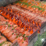 Raw chicken breasts seasoned with sweet chili sauce