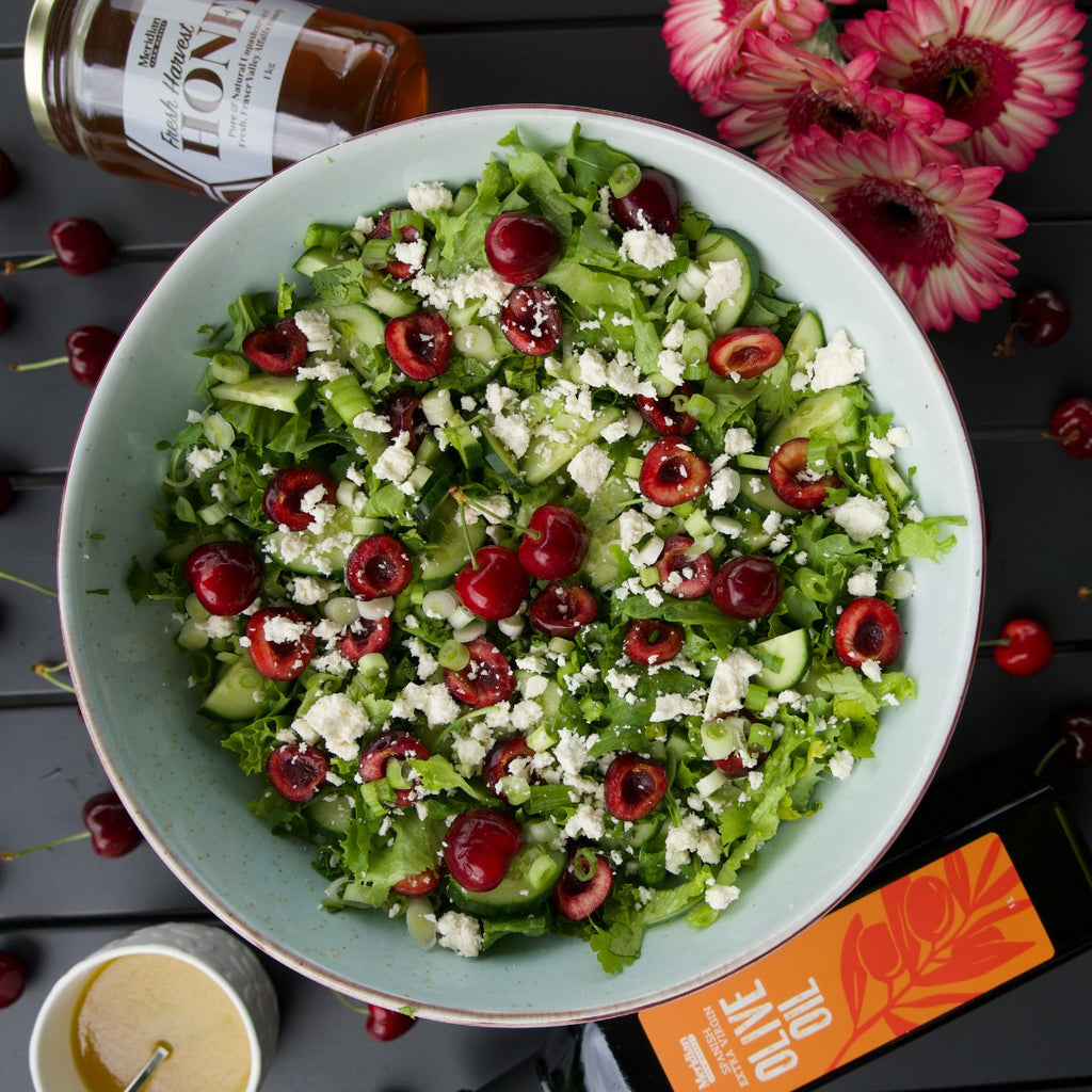 A summer cherry salad topped with Meridian Honey and Olive Oil.