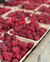 Close up of small boxes of local fresh raspberries