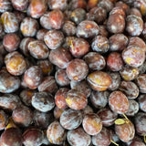 A mound of black plums up close