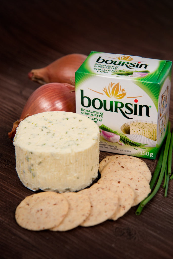 Boursin shallot and chives flavoured cheese displayed in front of crackers