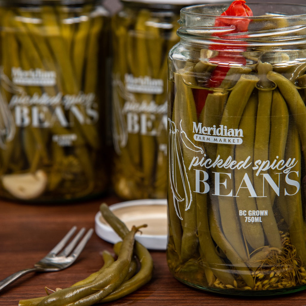 Meridian Pickled Spicy Beans 750ml jar opened and displayed four pickled green beans.